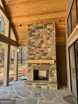 view of patio featuring an outdoor stone fireplace