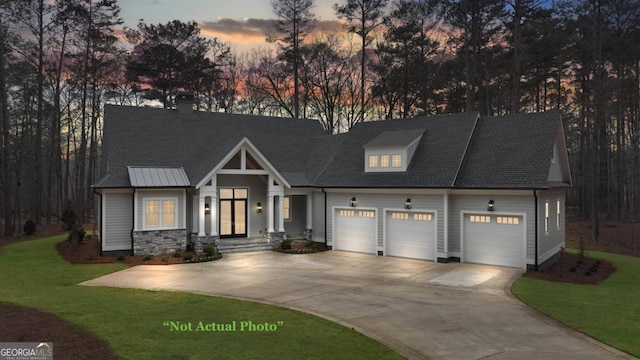 view of front facade with a yard and a garage