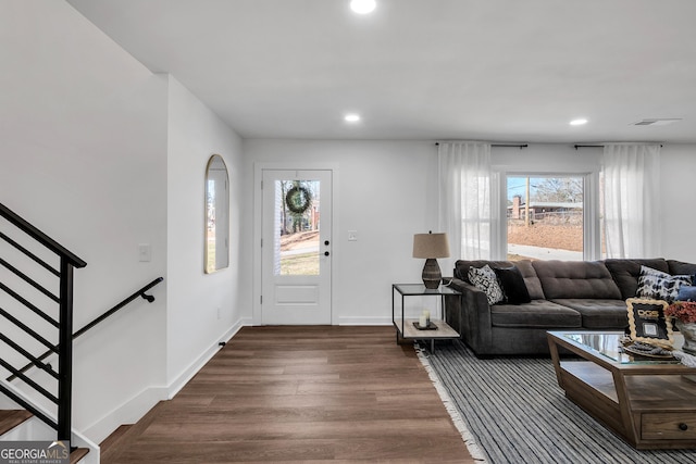 living room featuring plenty of natural light and dark hardwood / wood-style flooring