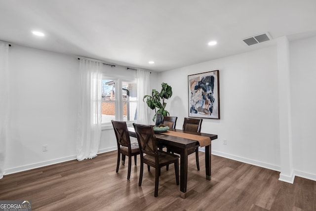 dining room with dark wood-type flooring