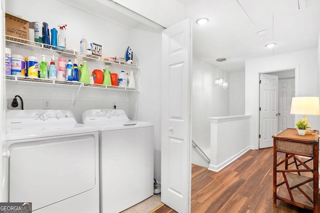 washroom with attic access, washing machine and dryer, dark wood-type flooring, laundry area, and baseboards