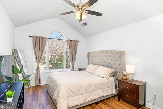 bedroom featuring visible vents, ceiling fan, vaulted ceiling, wood finished floors, and baseboards