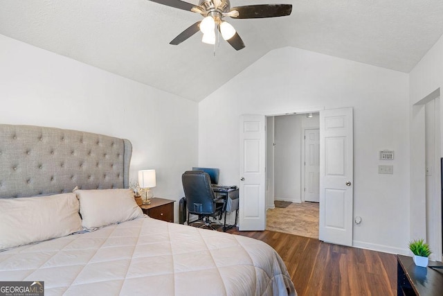 bedroom featuring a ceiling fan, baseboards, vaulted ceiling, and wood finished floors