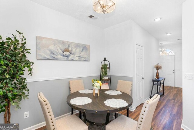 dining room featuring light wood-type flooring and a textured ceiling