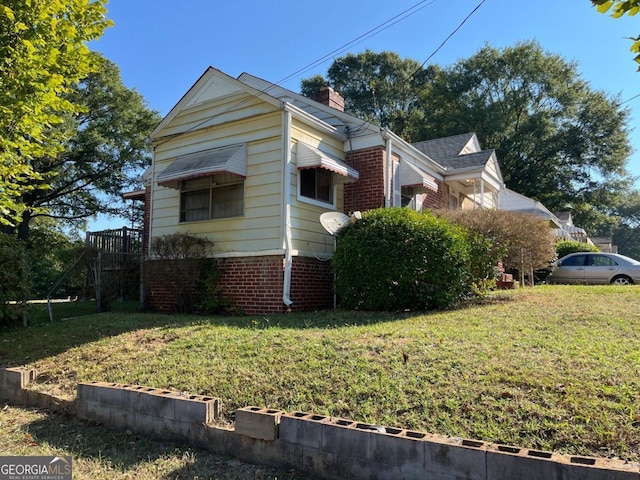 view of property exterior featuring a lawn