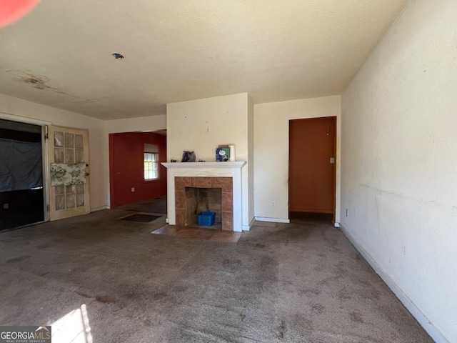 unfurnished living room featuring a fireplace and carpet