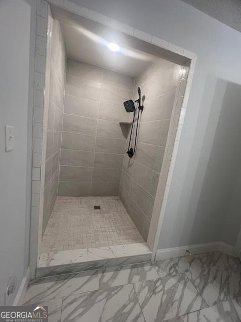 bathroom with tiled shower