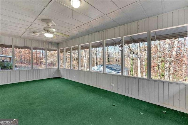 unfurnished sunroom featuring ceiling fan