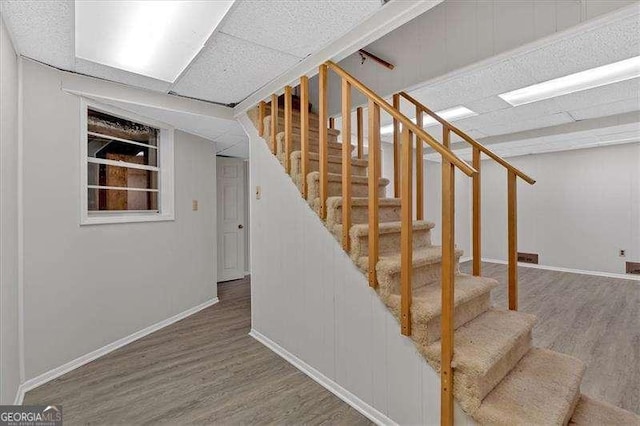 staircase with hardwood / wood-style floors