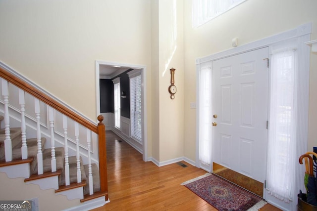 entrance foyer with wood-type flooring and ornamental molding