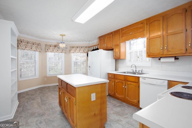 kitchen featuring sink, white appliances, hanging light fixtures, a center island, and tasteful backsplash