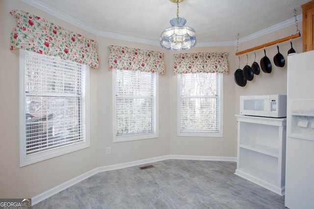 unfurnished dining area with ornamental molding