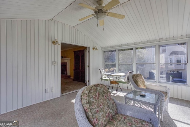 sunroom / solarium featuring ceiling fan and vaulted ceiling