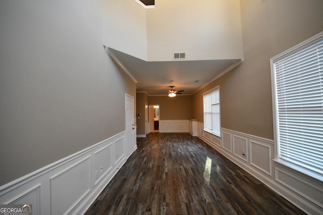 interior space featuring crown molding, ceiling fan, and dark hardwood / wood-style flooring