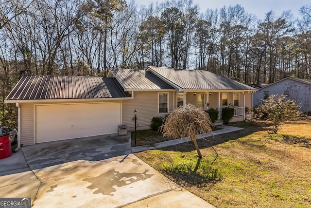 single story home with a porch, a garage, and a front lawn