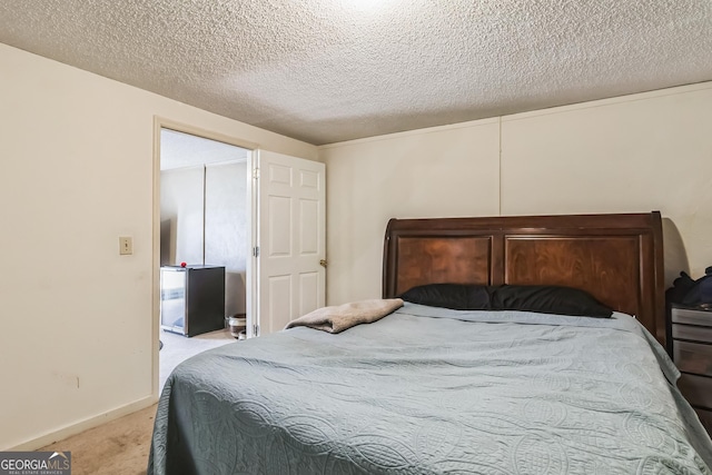 carpeted bedroom featuring a textured ceiling