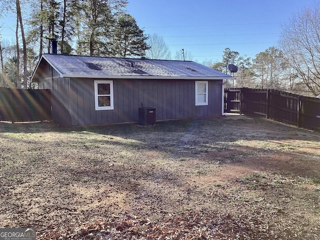 back of property featuring central AC