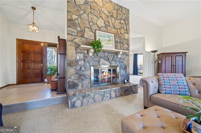 living room featuring a stone fireplace, light carpet, and a high ceiling