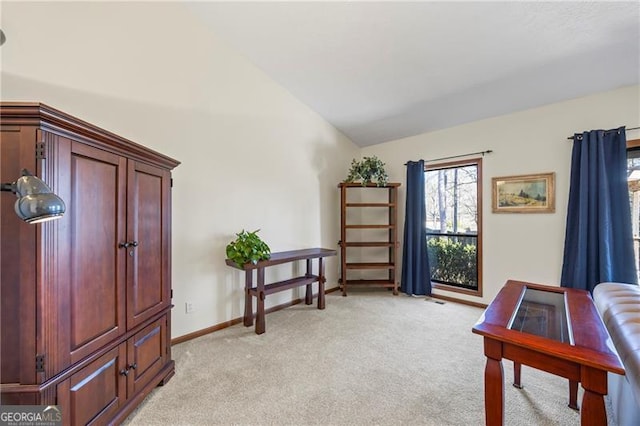 sitting room featuring light carpet and lofted ceiling