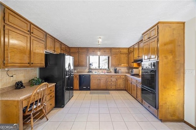 kitchen featuring light tile patterned floors, backsplash, and black appliances