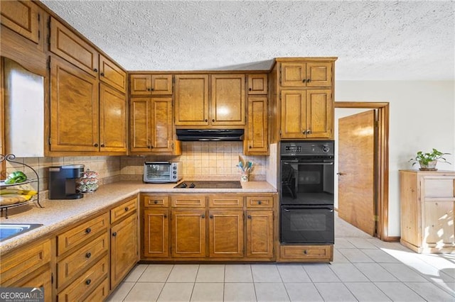 kitchen with black appliances, decorative backsplash, and light tile patterned floors