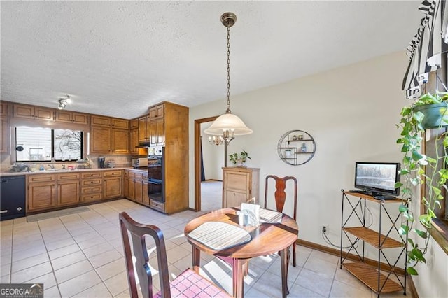 dining room featuring light tile patterned floors and a textured ceiling