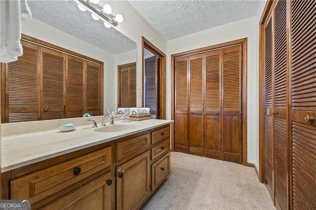 bathroom with vanity and a textured ceiling