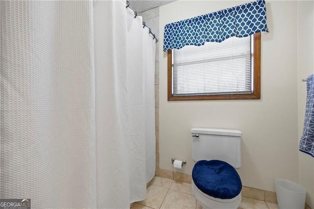 bathroom featuring tile patterned flooring and toilet