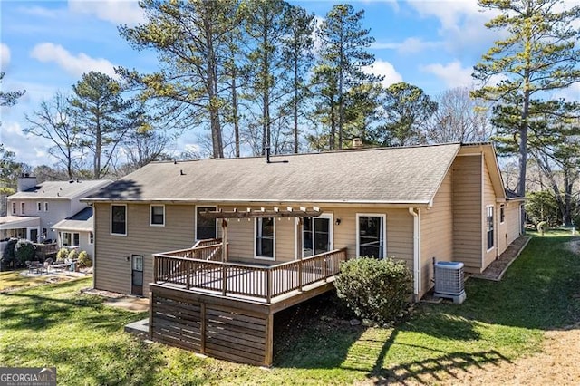 back of house with a yard, a deck, and central AC unit