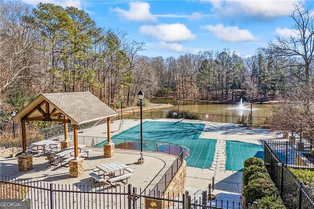 view of swimming pool featuring a gazebo, a water view, and a patio area