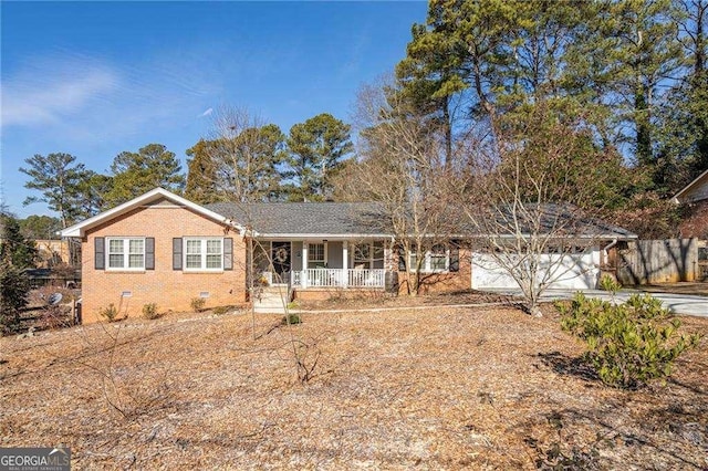 ranch-style house with a garage and covered porch