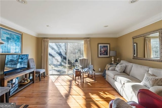 living room featuring light hardwood / wood-style flooring and ornamental molding