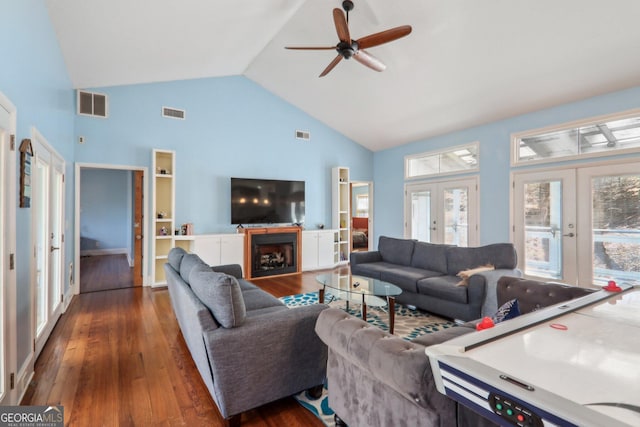 living room with ceiling fan, french doors, dark wood-type flooring, and high vaulted ceiling