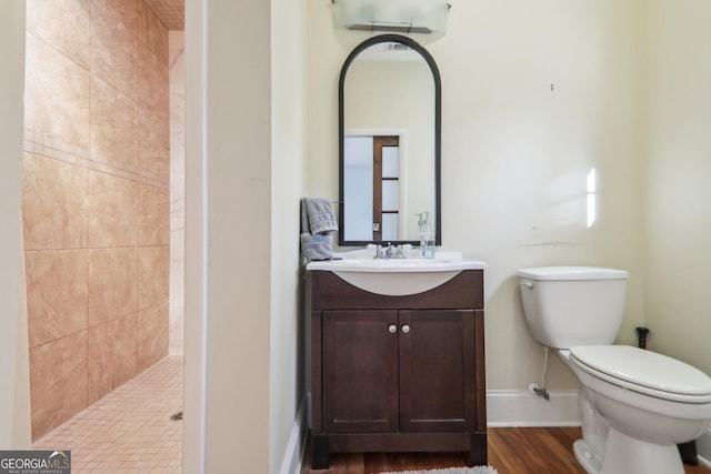 bathroom with a shower, wood-type flooring, toilet, and vanity