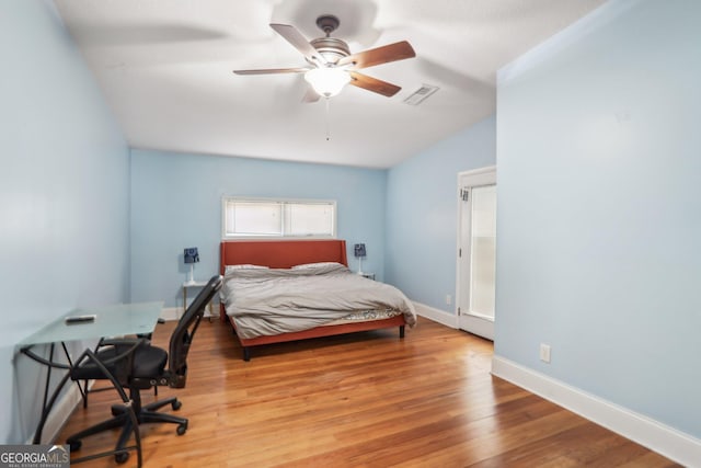 bedroom featuring light wood-type flooring, ceiling fan, and vaulted ceiling