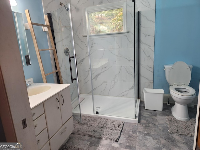 bathroom featuring toilet, vanity, and a shower with door