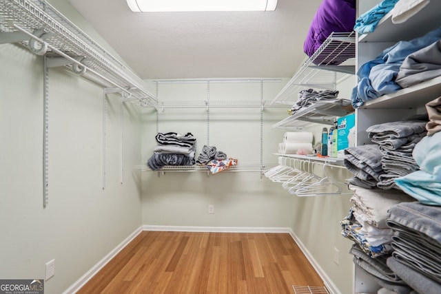 spacious closet featuring hardwood / wood-style floors