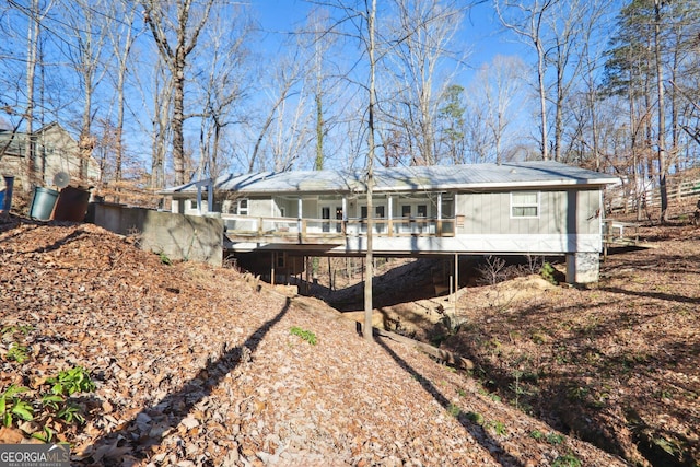 back of house featuring a wooden deck