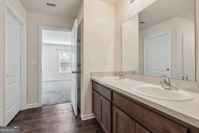 bathroom with vanity and hardwood / wood-style flooring