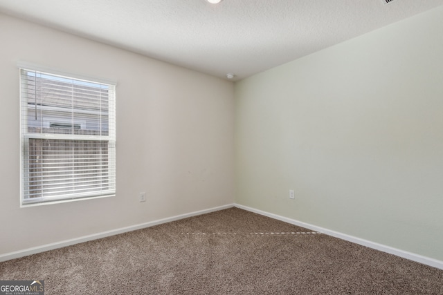 unfurnished room featuring carpet