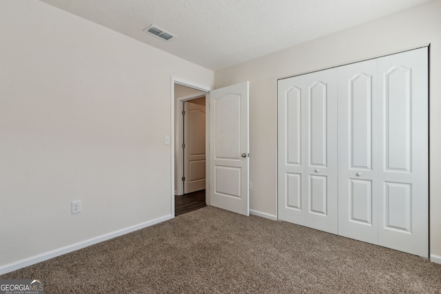 unfurnished bedroom featuring a closet and carpet