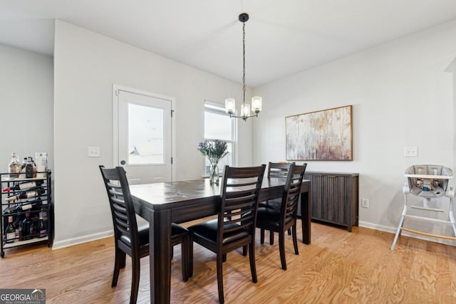 dining room featuring light hardwood / wood-style floors and a notable chandelier