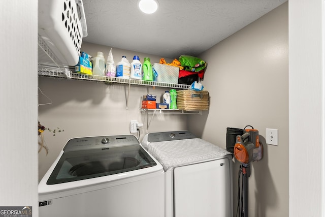 clothes washing area with washing machine and clothes dryer