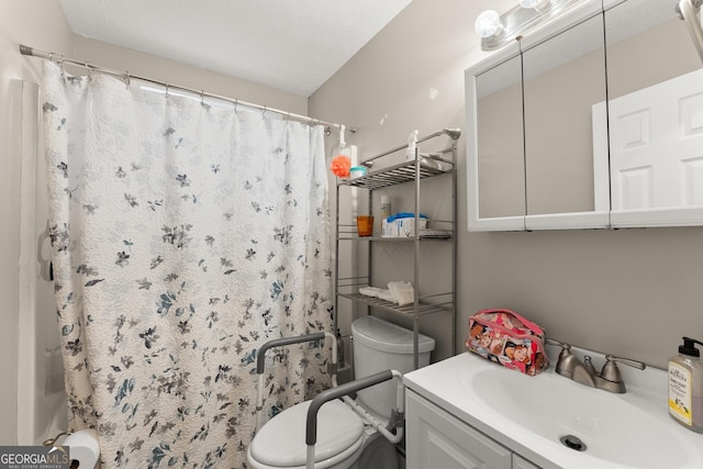 bathroom featuring vanity, toilet, and walk in shower