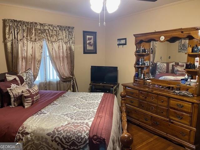 bedroom featuring crown molding and hardwood / wood-style floors