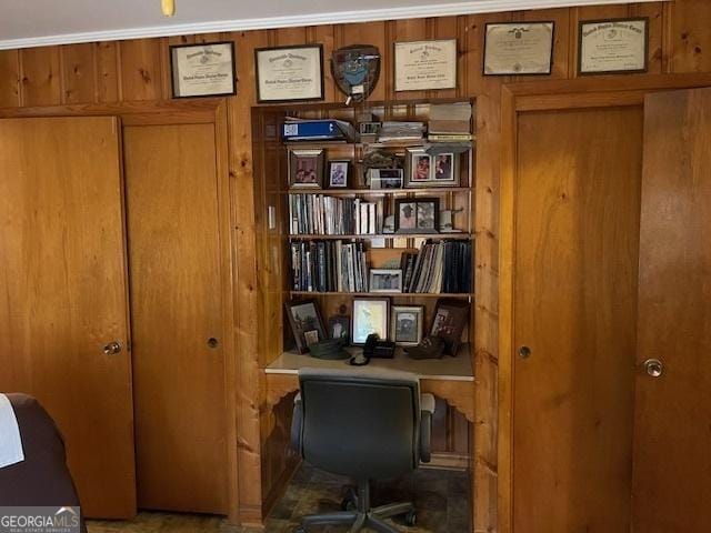 office area featuring wooden walls and crown molding