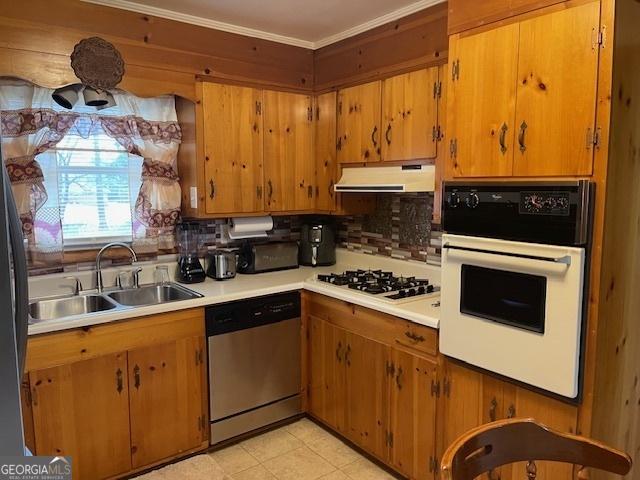 kitchen featuring sink, white appliances, decorative backsplash, and ornamental molding