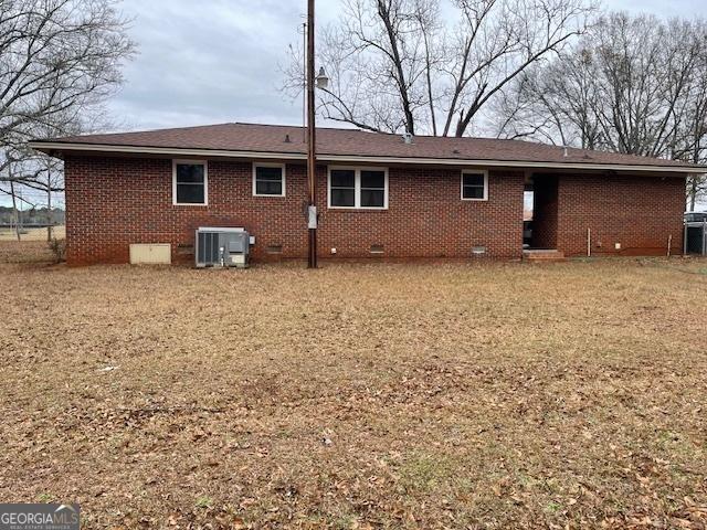 back of house featuring cooling unit