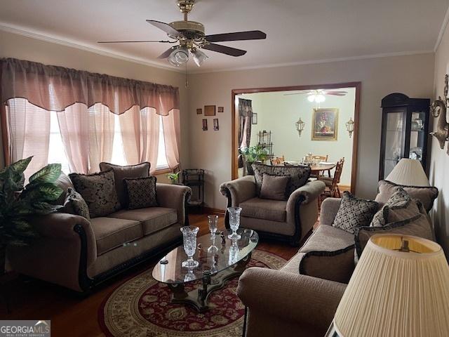 living room with ornamental molding and hardwood / wood-style floors