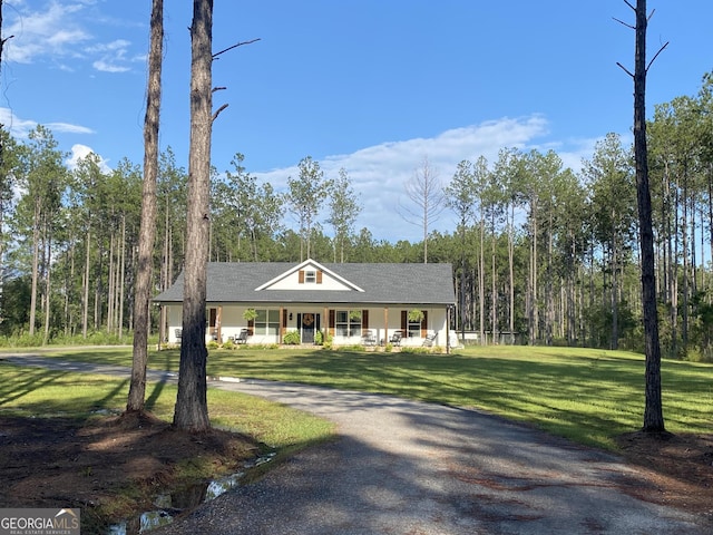 ranch-style home featuring a porch and a front lawn